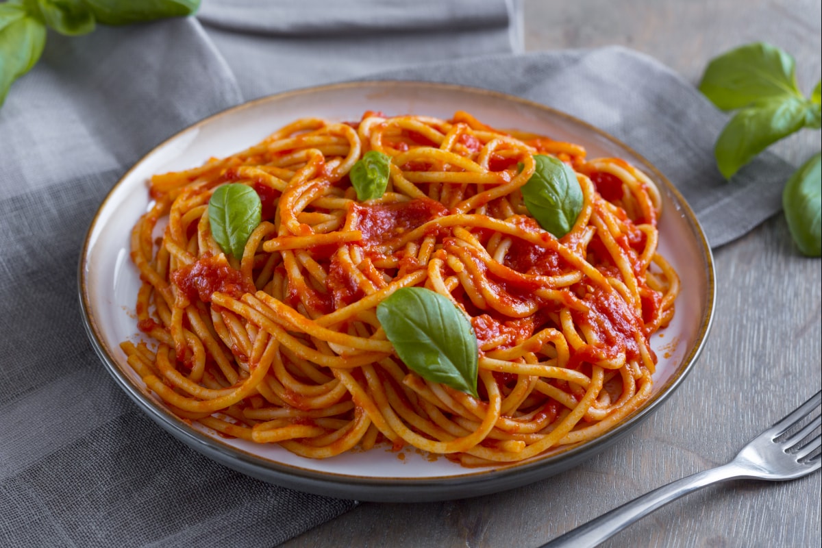 Fresh spaghetti with vibrant tomato sauce and basil