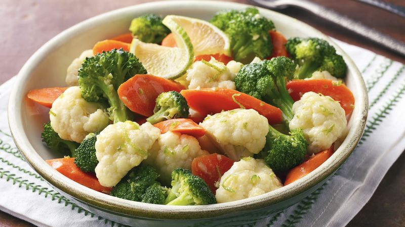 Bowl of steamed vegetables with lime